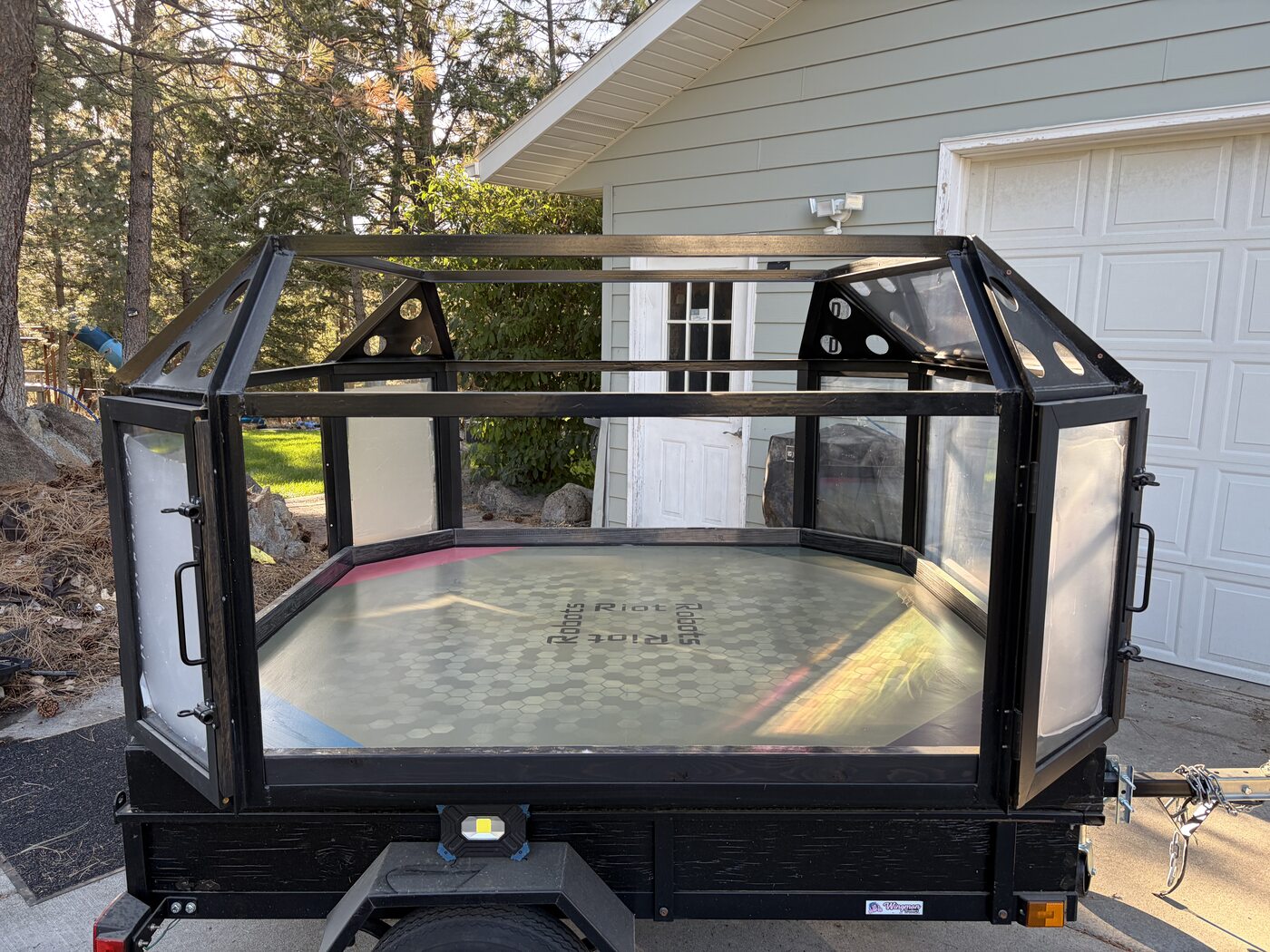 The trailer-mounted Riot Robots arena outdoors in its current nearly complete physical state