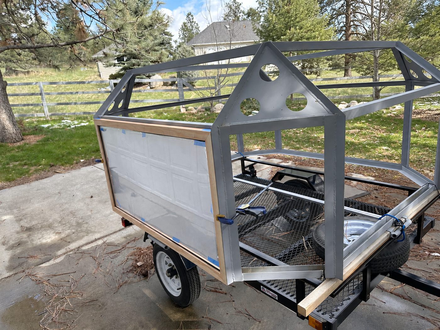 The early welded arena cage mounted on the utility trailer during the first panel test-fitting